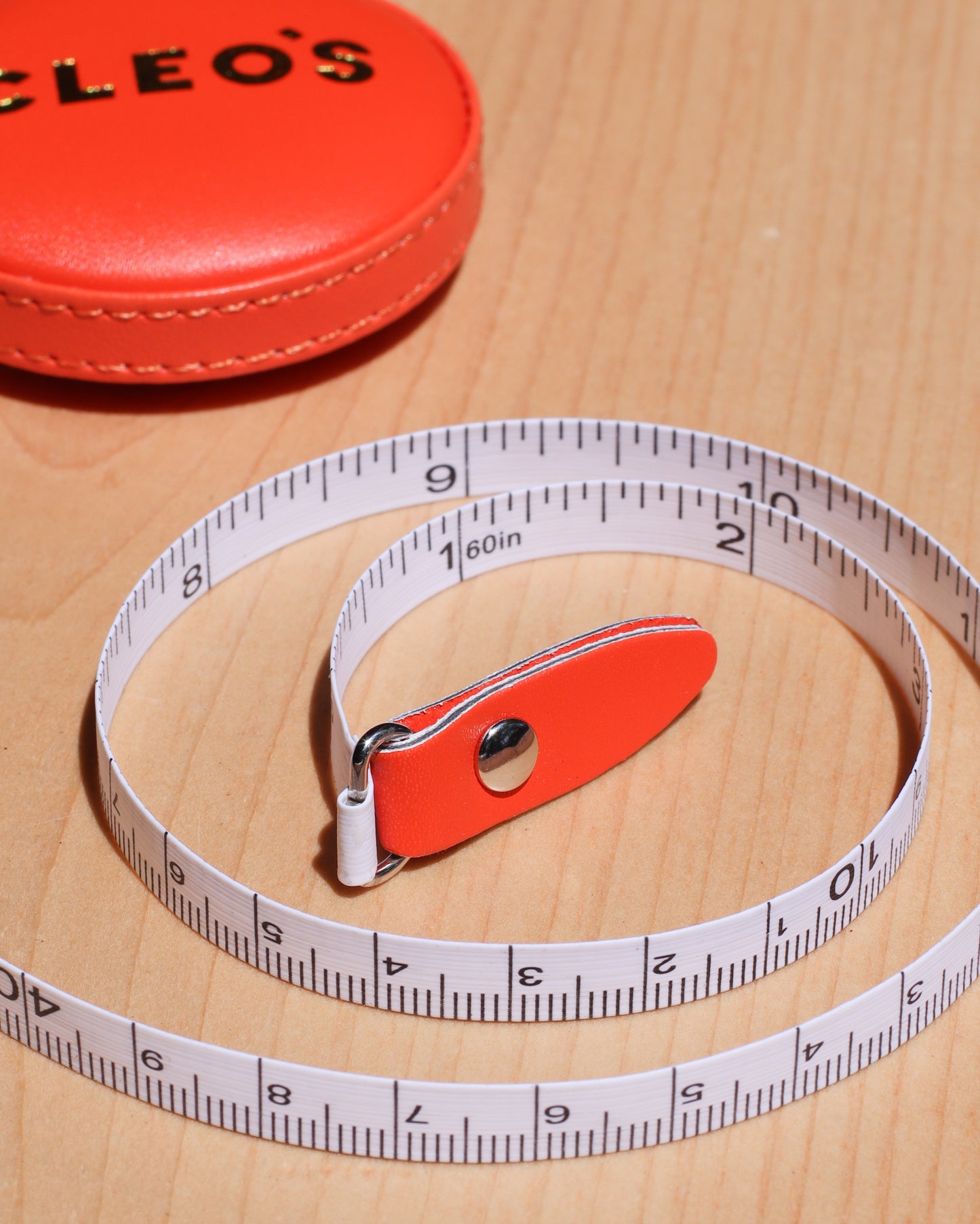 CLEO'S Red-Orange Tape Measure