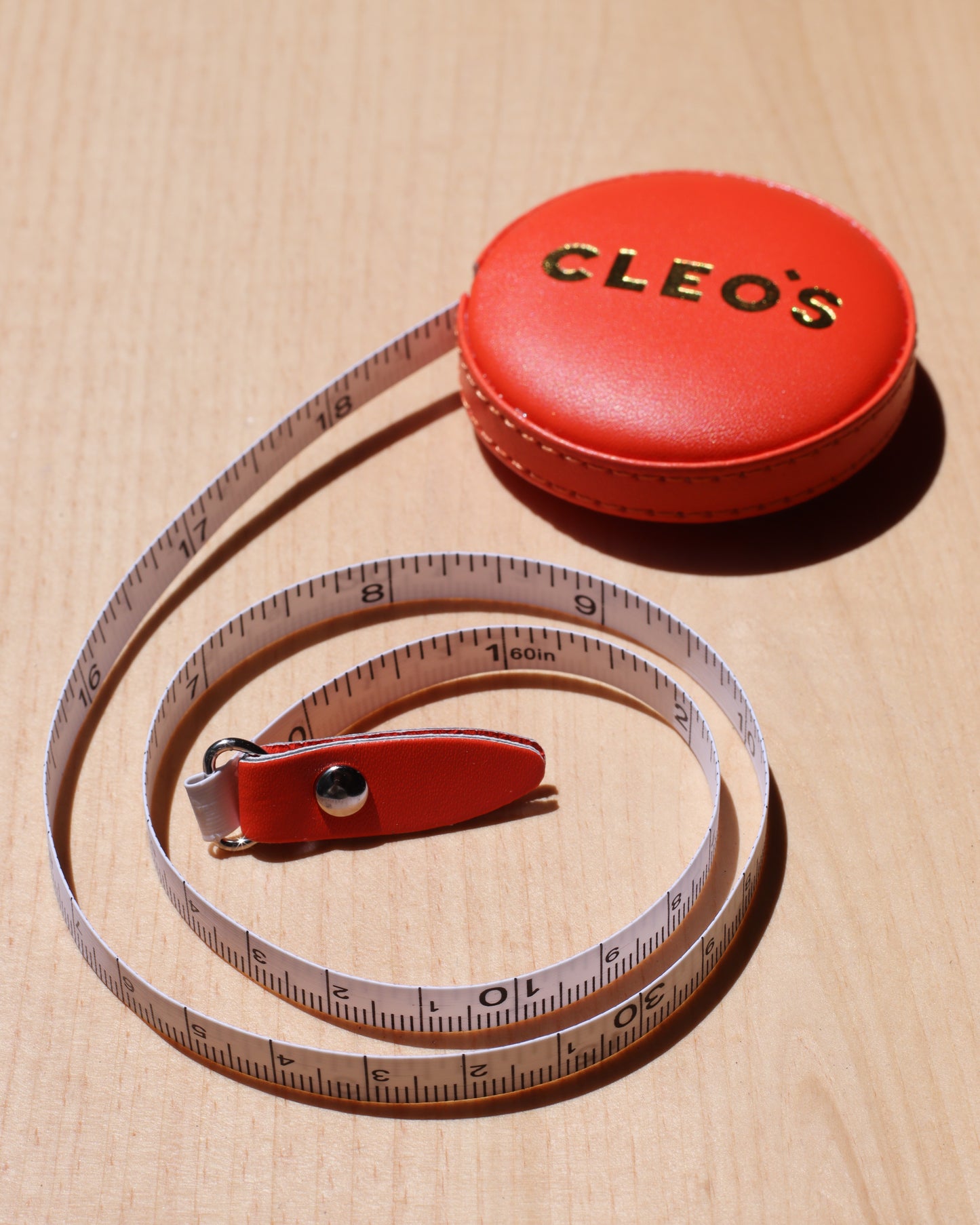 CLEO'S Red-Orange Tape Measure